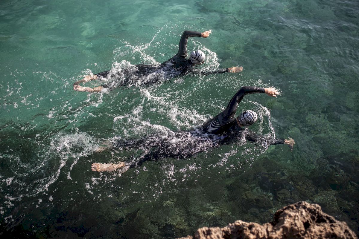 Swimmers with neoprene in the sea