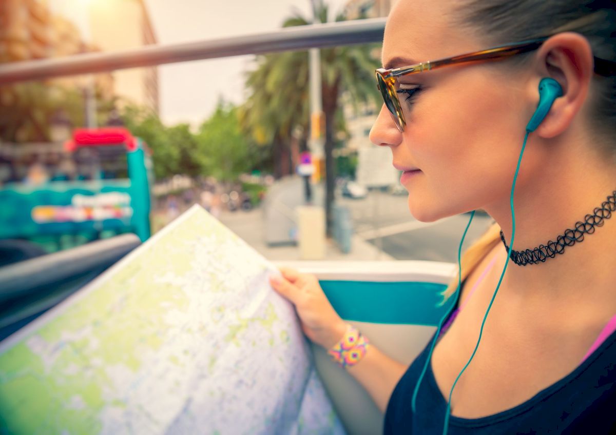 Women with earphones from Actia in a touristic bus