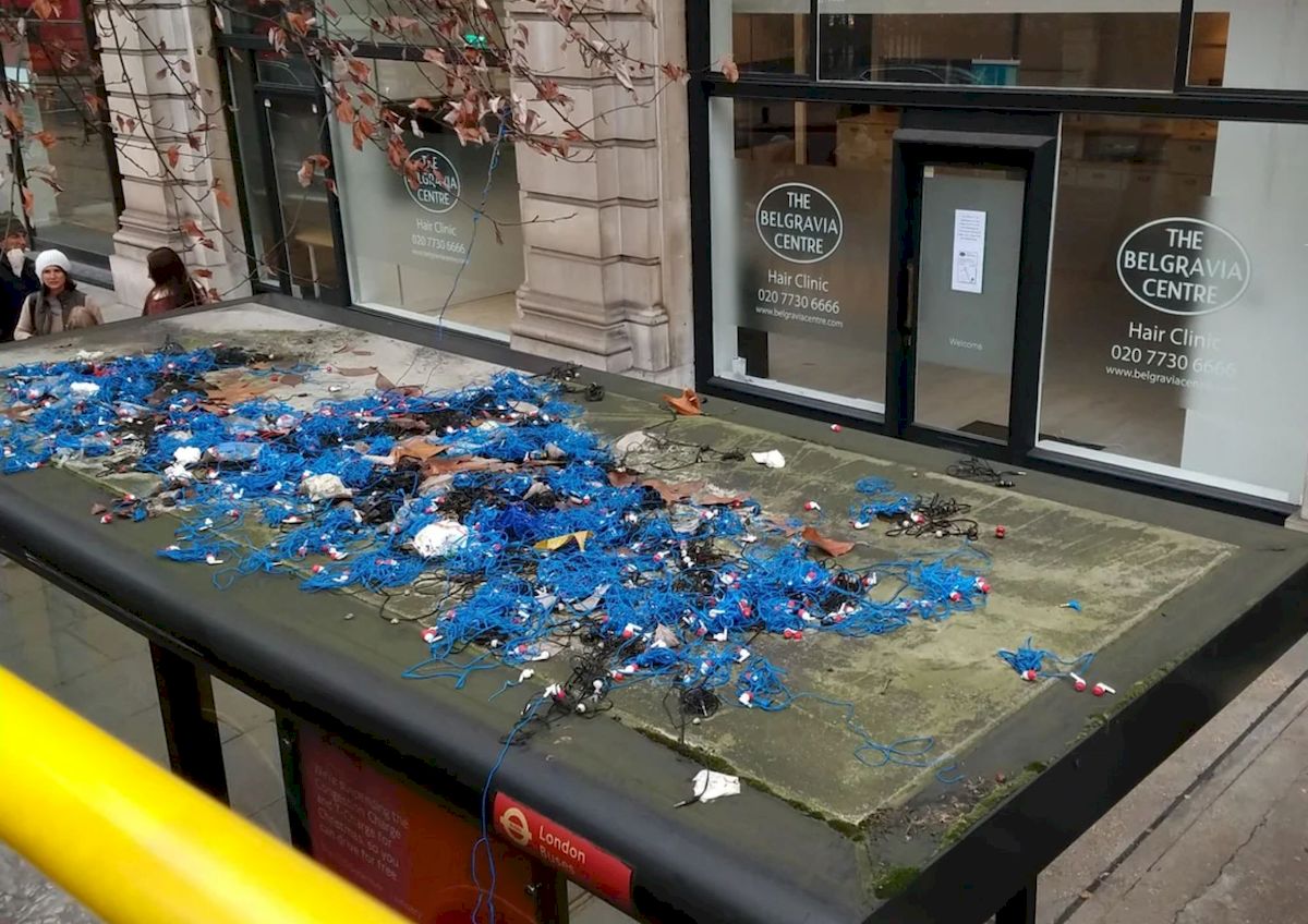 Discarded earphones thrown away on a bus stop